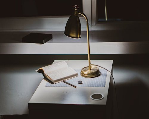 A well placed reading lamp on a desk